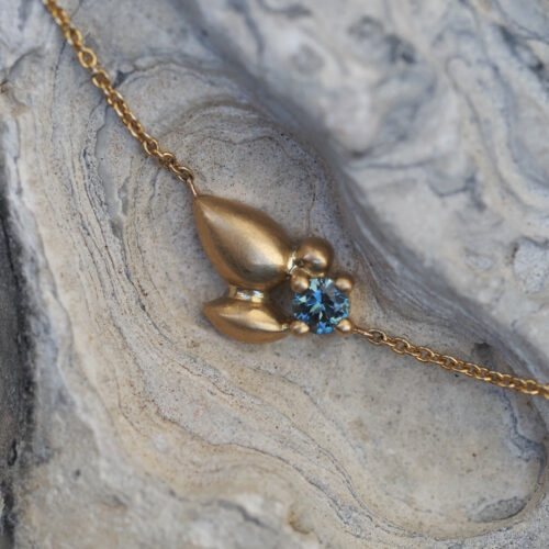 Australian sapphire eucalypt pendant by Marina Antoniou in yellow gold